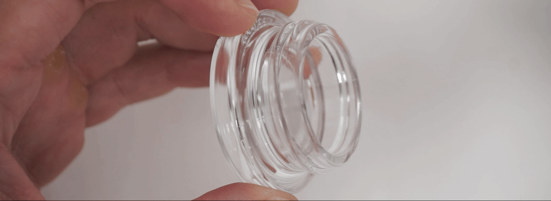 Goodlook Classic glass concentrate jar demonstrating the magnifying effect built into the molded glass base